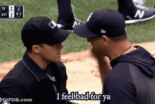 A Man In A Ny Yankees Hat Talks To Another Man On A Baseball Field GIF