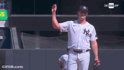 A Man In A Ny Yankees Uniform Is Waving GIF