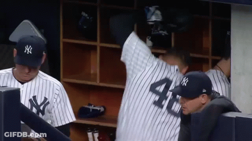 A Man In A Ny Yankees Uniform Stands In The Dugout GIF