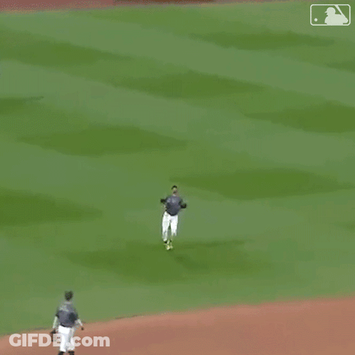 A Man In A Nyc Jersey Is Dancing On The Field . GIF