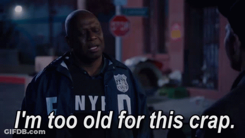 A Man In A Nypd Jacket Talks To Another Man GIF