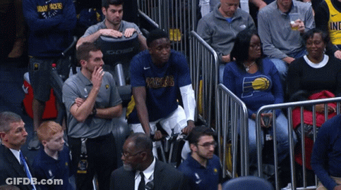 A Man In A Pacers Shirt Sits In The Stands Watching A Game GIF