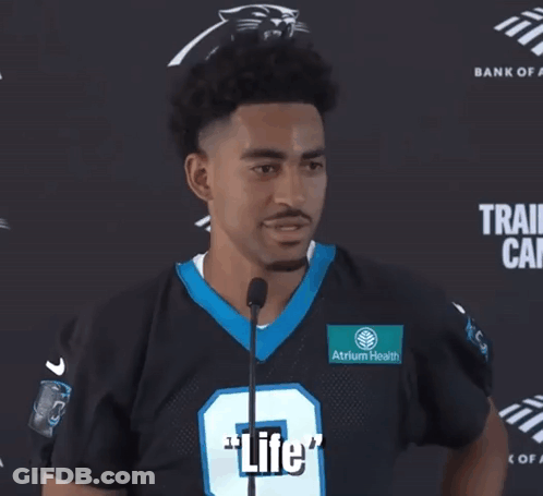 A Man In A Panthers Jersey Is Talking Into A Microphone And Says " What A Beautiful Thing " GIF