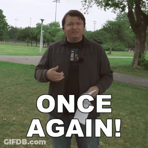 A Man In A Park Holding A Piece Of Paper That Says Once Again On It GIF