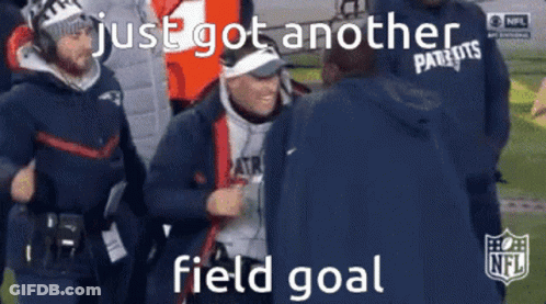 A Man In A Patriots Jacket Is Talking To Another Man On A Football Field GIF