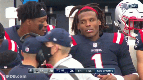 A Man In A Patriots Jersey Is Sitting On The Bench GIF