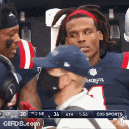 A Man In A Patriots Jersey Is Talking To A Man In A Hat GIF