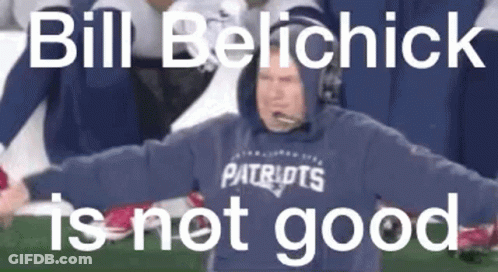 A Man In A Patriots Sweatshirt Is Standing On A Football Field . GIF