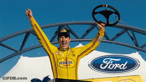A Man In A Pennzoil Shirt Holds A Steering Wheel In His Hand GIF