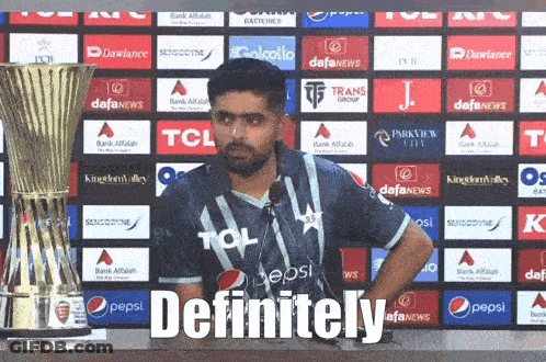 A Man In A Pepsi Shirt Stands In Front Of A Trophy And Says Definitely GIF