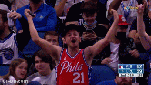 A Man In A Philadelphia Jersey Is Cheering GIF