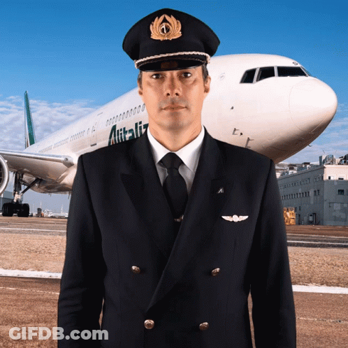 A Man In A Pilot 'S Uniform Stands In Front Of An Alitalia Airplane GIF