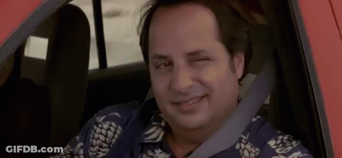 A Man In A Pineapple Shirt Is Sitting In A Car And Smiling . GIF