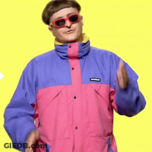 A Man In A Pink And Blue Jacket And Sunglasses Is Dancing . GIF