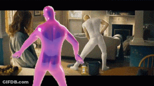 A Man In A Pink Bodysuit Is Dancing In A Living Room With Other People GIF