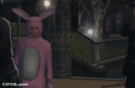 A Man In A Pink Bunny Costume Is Standing Next To A Man In A Black Suit GIF