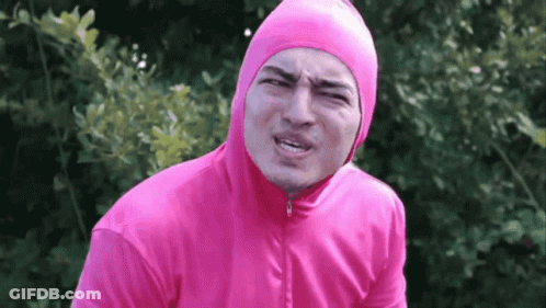 A Man In A Pink Hoodie Is Making A Face GIF