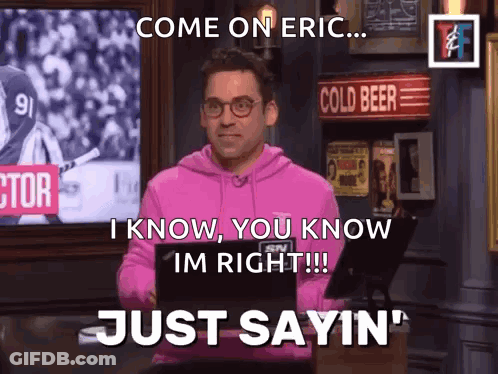 A Man In A Pink Hoodie Is Standing In Front Of A Sign That Says Cold Beer GIF