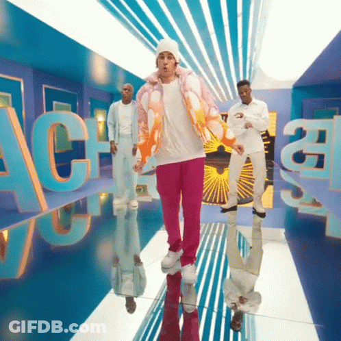 A Man In A Pink Jacket And Pink Pants Is Dancing In A Room With The Letters Ac On It GIF