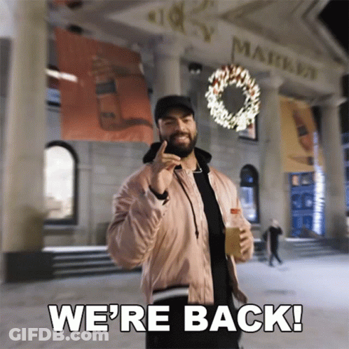 Pink Jacket Man Holding Bottle Saying We're Back GIF