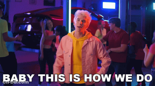 A Man In A Pink Jacket Stands In Front Of A Crowd With The Words Baby This Is How We Do GIF
