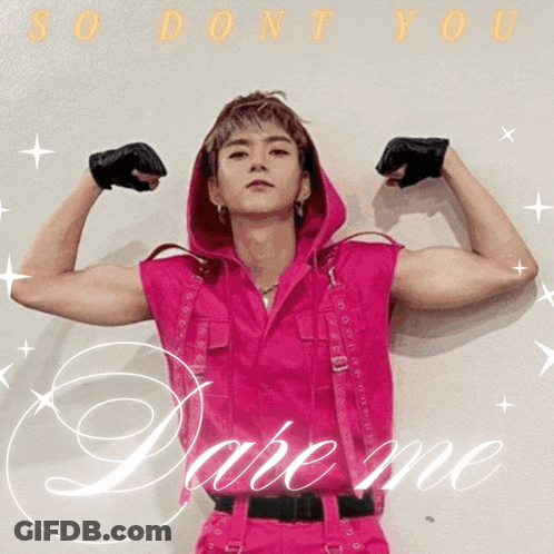 A Man In A Pink Outfit Is Flexing His Muscles And The Words Dare Me Are Behind Him GIF
