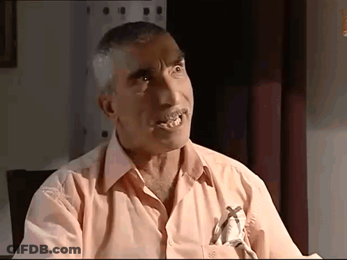 A Man In A Pink Shirt Has A Cross On His Pocket GIF