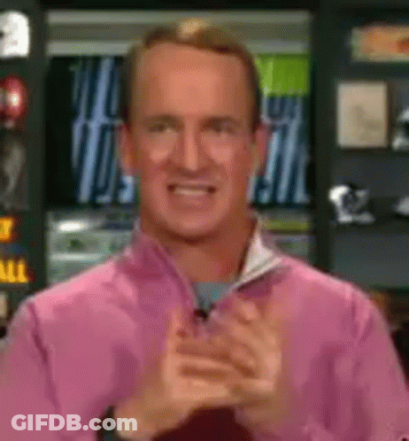 A Man In A Pink Shirt Is Clapping And Smiling GIF