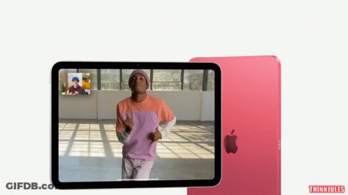 A Man In A Pink Shirt Is Dancing On A Tablet Screen GIF