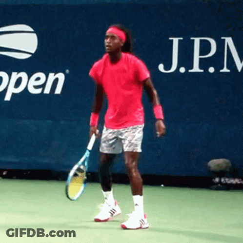 A Man In A Pink Shirt Is Holding A Tennis Racquet In Front Of An Open Sign GIF