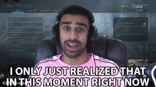 A Man In A Pink Shirt Is Playing A Video Game And Says " I Only Just Realized That In This Moment Right Now " GIF