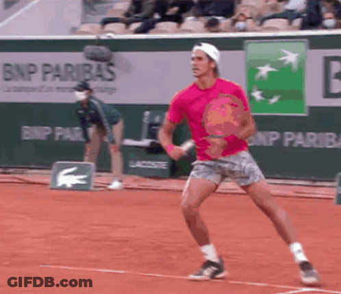 A Man In A Pink Shirt Is Playing Tennis In Front Of A Bnp Paribas Banner GIF