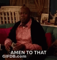 A Man In A Pink Shirt Is Sitting On A Couch Drinking A Glass Of Wine And Says Amen To That . GIF