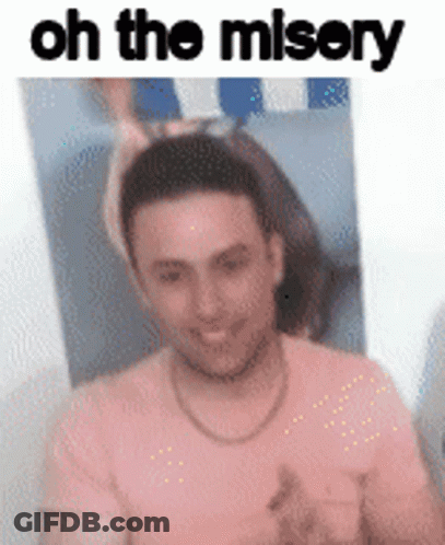 A Man In A Pink Shirt Is Smiling In Front Of A Picture Of A Woman And The Words `` Oh The Misery '' . GIF