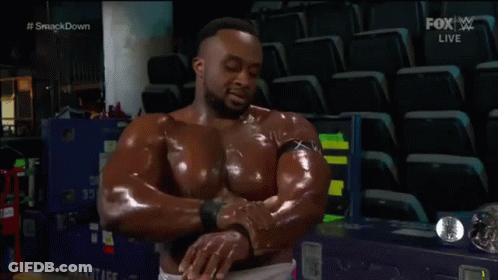 A Man In A Pink Shirt Is Standing Next To A Wrestling Wrestler . GIF