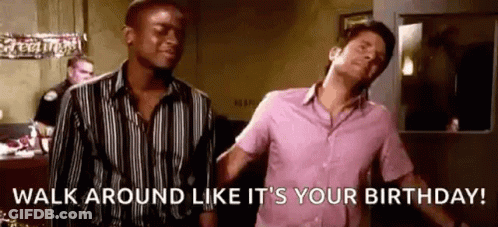 A Man In A Pink Shirt Is Standing Next To Another Man In A Black And White Striped Shirt . GIF