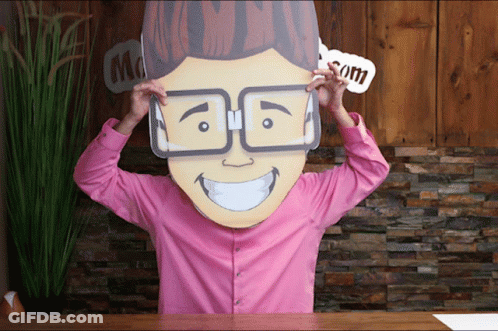 A Man In A Pink Shirt Is Wearing A Cardboard Head With Glasses On GIF