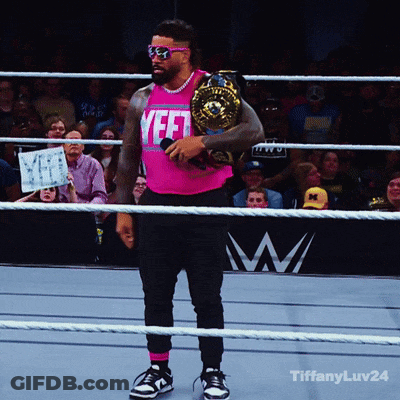 A Man In A Pink Shirt That Says Yeet Holds A Championship Belt GIF