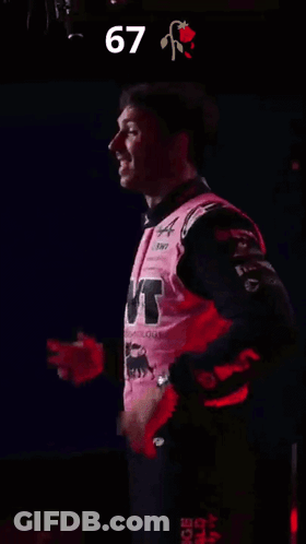 A Man In A Pink Shirt With The Number 67 On The Bottom GIF