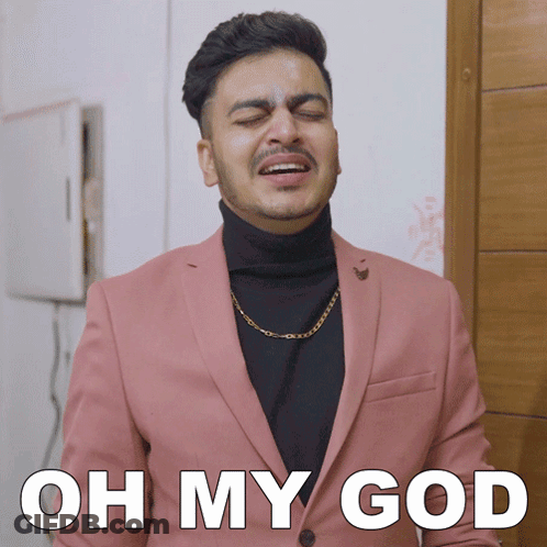 A Man In A Pink Suit And Black Turtleneck Is Making A Funny Face With The Words Oh My God Below Him GIF