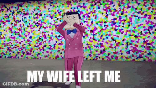 A Man In A Pink Suit And Bow Tie Is Standing In Front Of A Colorful Wall Covering His Eyes With His Hands . GIF