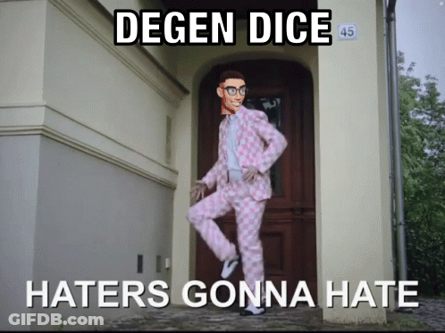 A Man In A Pink Suit Is Standing In Front Of A Door With The Words Degen Dice Haters Gonna Hate GIF
