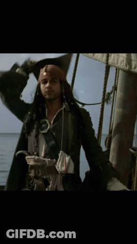 A Man In A Pirate Costume Is Standing On A Boat GIF