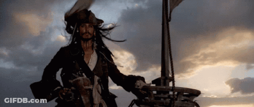 A Man In A Pirate Costume Is Standing On Top Of A Ship . GIF