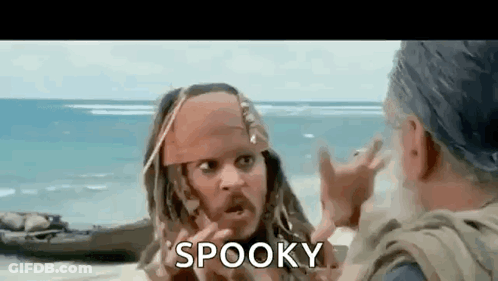 A Man In A Pirate Costume Is Talking To Another Man On A Beach And Says `` Spooky '' . GIF