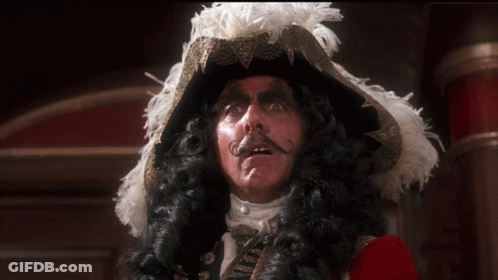 A Man In A Pirate Costume With A Feathered Hat And Mustache GIF