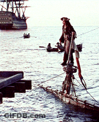 A Man In A Pirate Outfit Is Standing On A Boat In The Water GIF