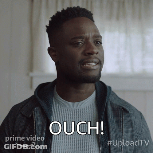 A Man In A Plaid Jacket Says Ouch In Front Of A Prime Video Logo GIF