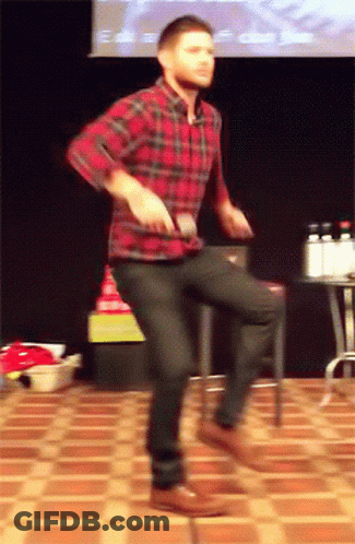 A Man In A Plaid Shirt And Black Jeans Is Dancing On A Tiled Floor GIF