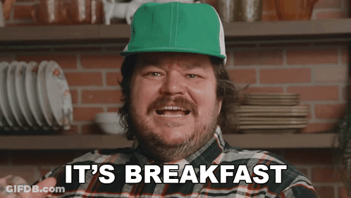 A Man In A Plaid Shirt And Green Hat Says It 'S Breakfast GIF